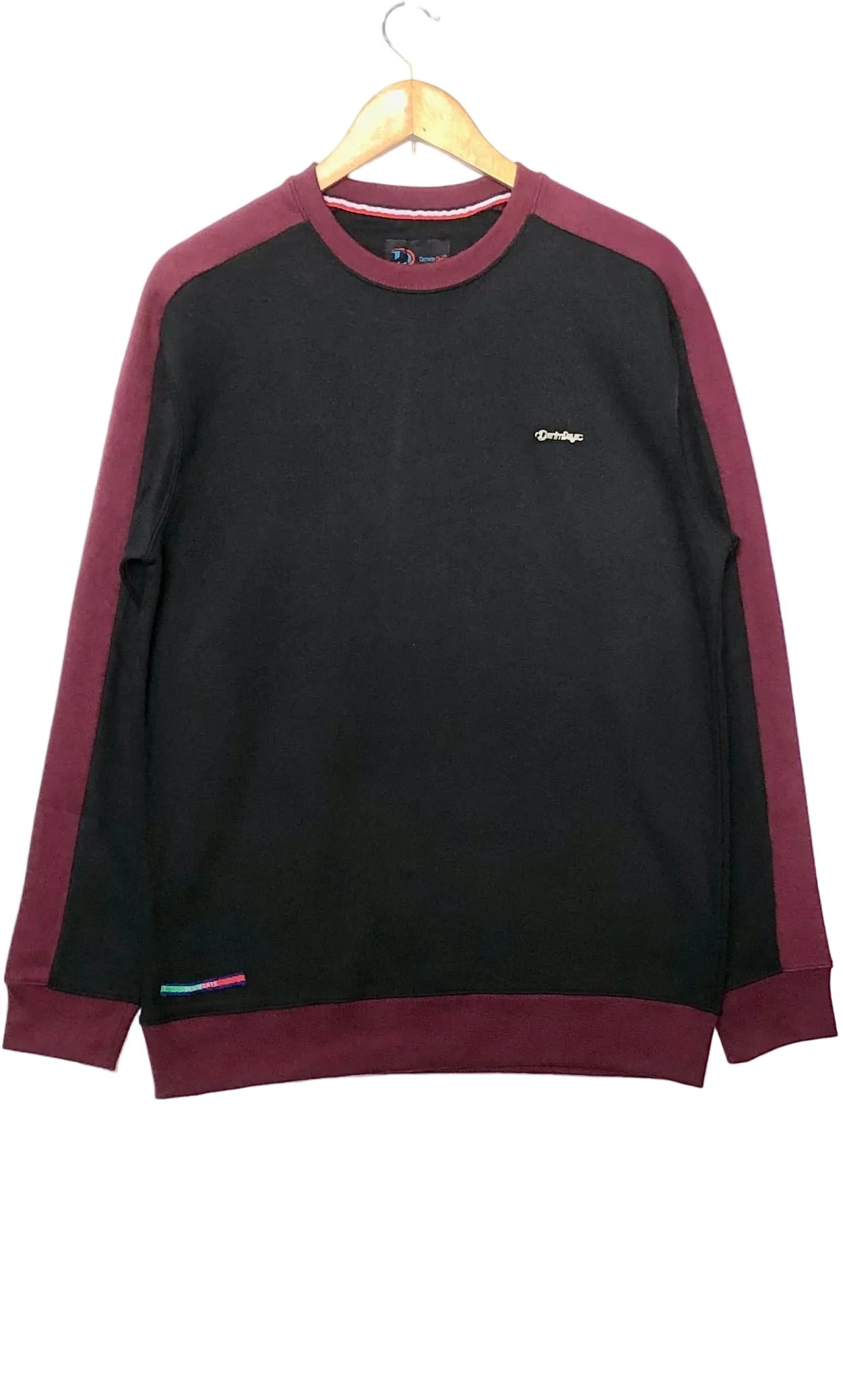 Black sweatshirt with maroon sleeves on a hanger against a white background